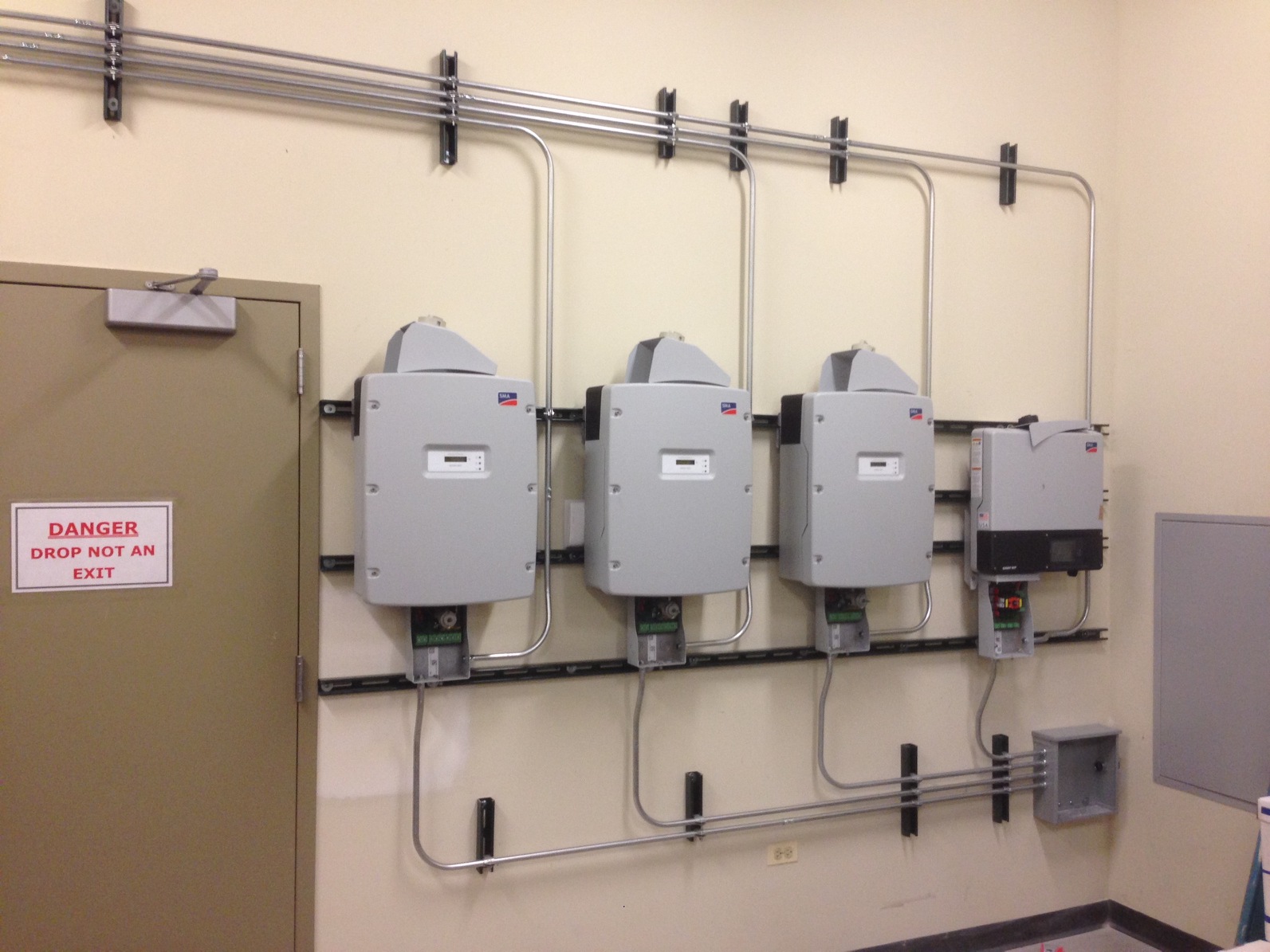 Sunny Boy inverters are ready for the final stages of installation inside the electrical room.