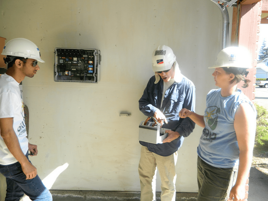 SMA's Sanket Shah and Mike Mahon installing the inverter's DC Disconnect.
